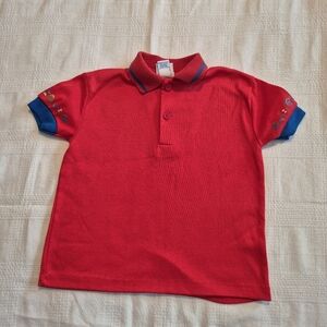 Vintage Oshkosh size 4T red short sleeve polo shirt has hole in the bottom back